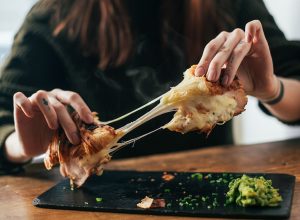 10 Signs You’re Eating Too Much Cheese, According to Doctors