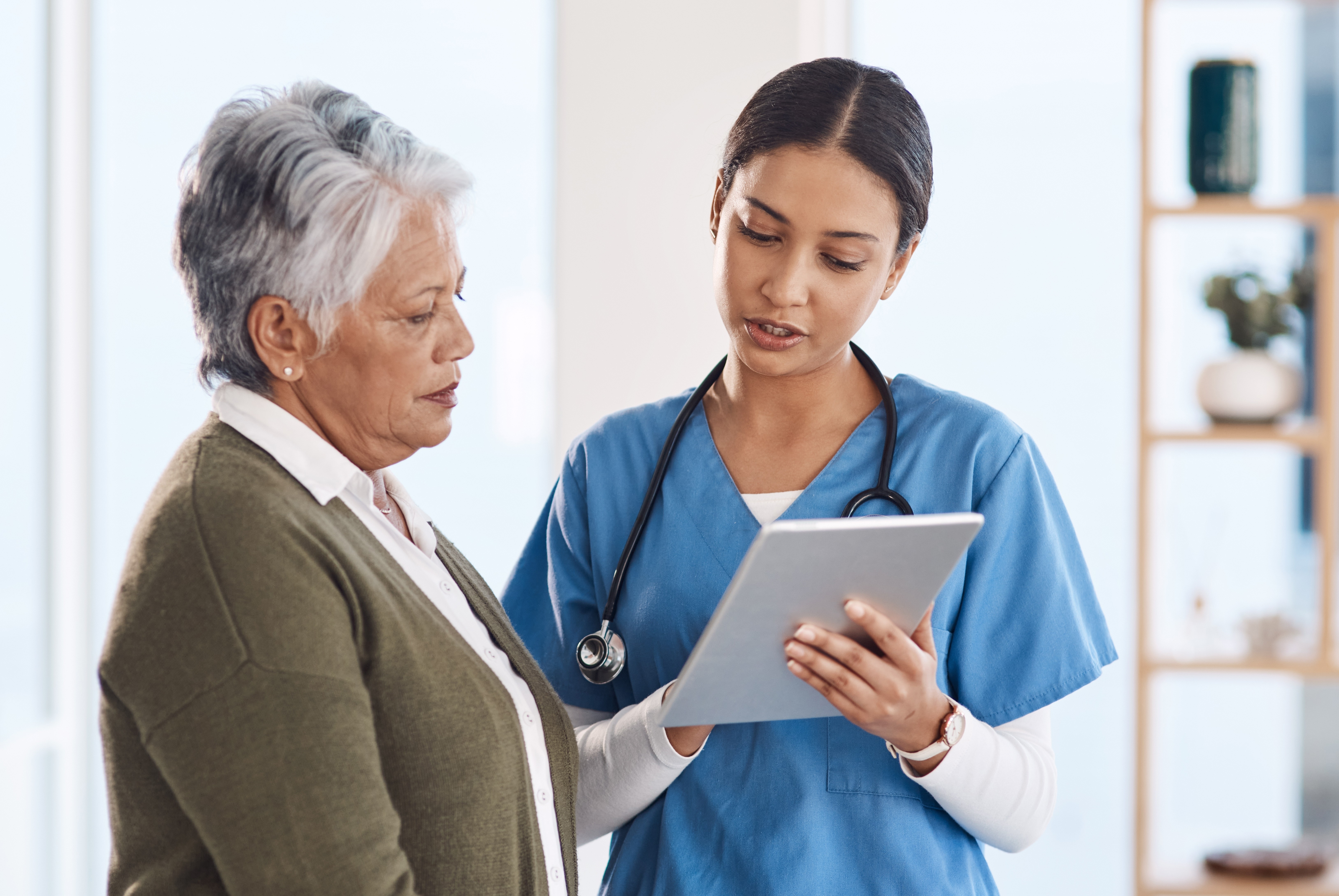 A woman patient and doctor with a tablet