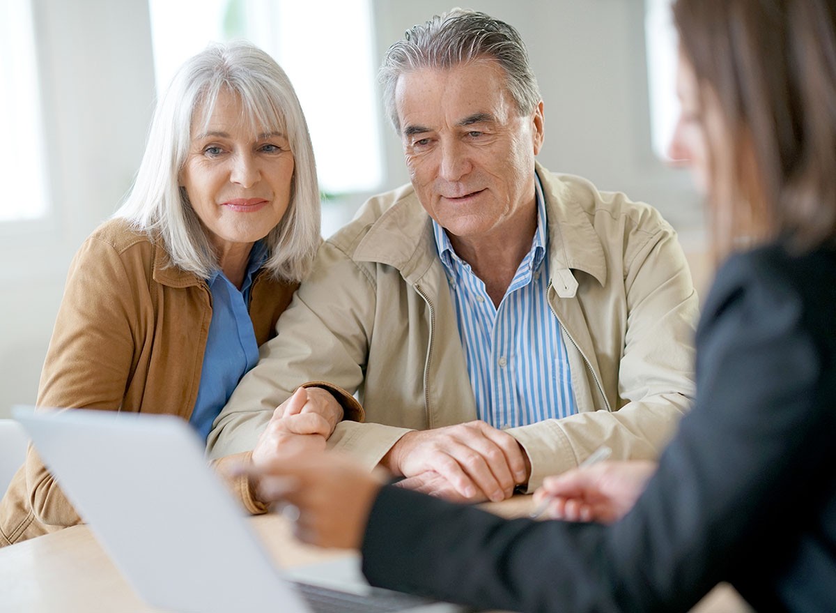 A senior couple meet with their financial advisor to discuss investments