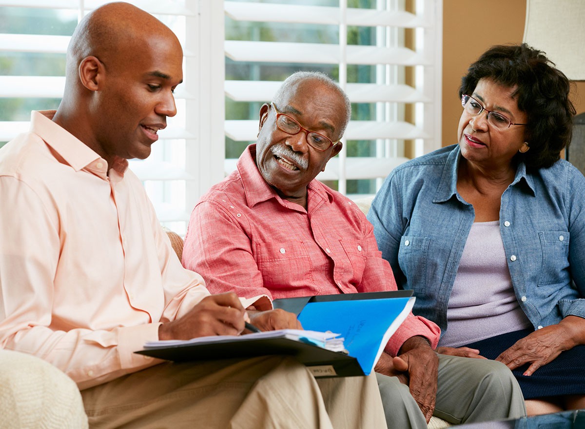 A financial  advisor talks to a couple at home.