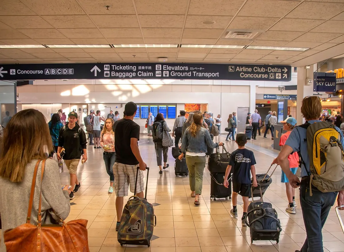 People with luggage at Minneapolis-Saint Paul International Airport