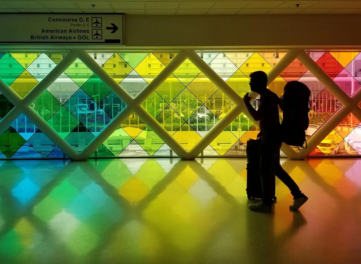 A passenger walks through the concourse of Miami International Airport