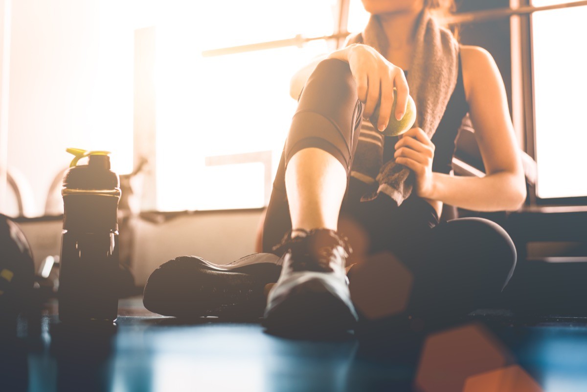A woman recovering after workout at the gym.