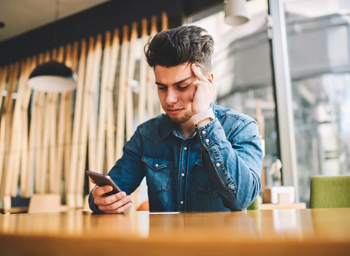 A man looking at text messages on his phone