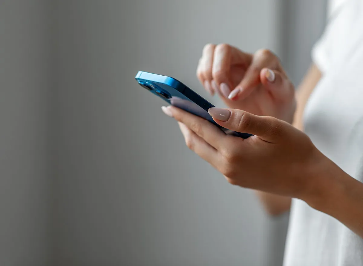 Hands texting on a phone