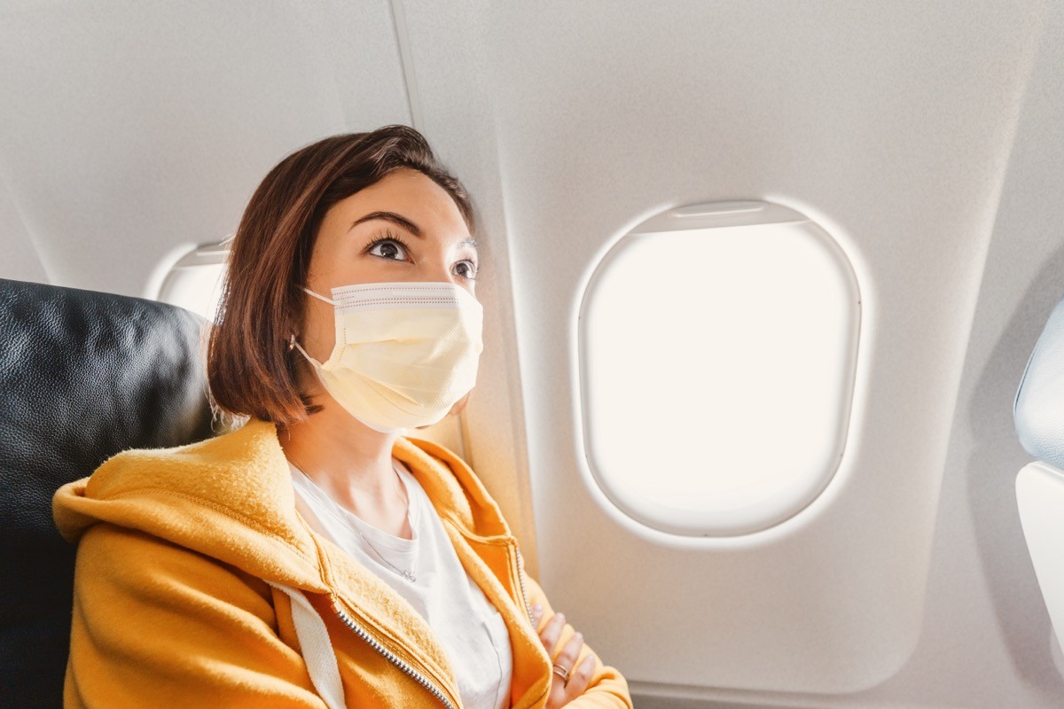 Girl wearing mask on a plane