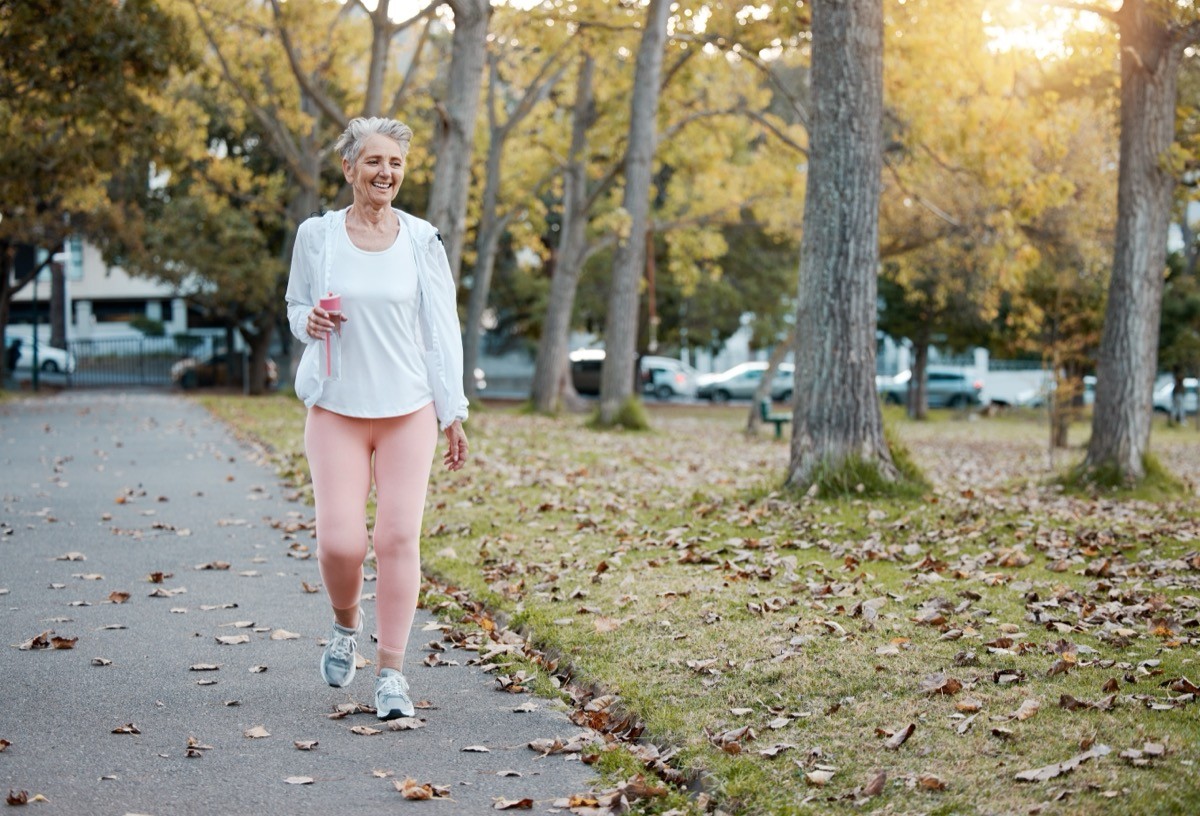 woman walking in a park in the fall