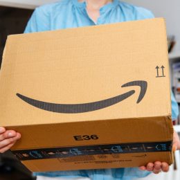 closeup of a woman holding an amazon box