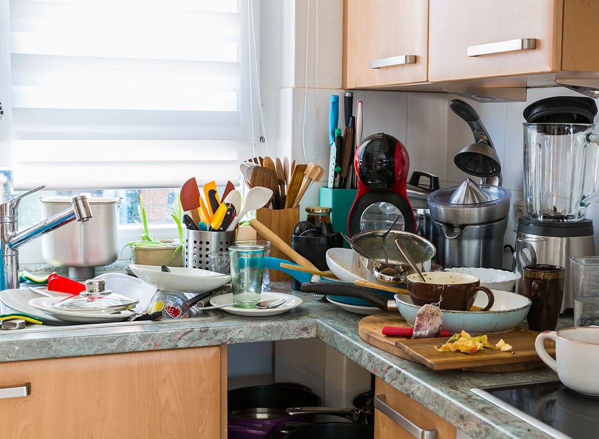 A messy kitchen with clutter on the counter