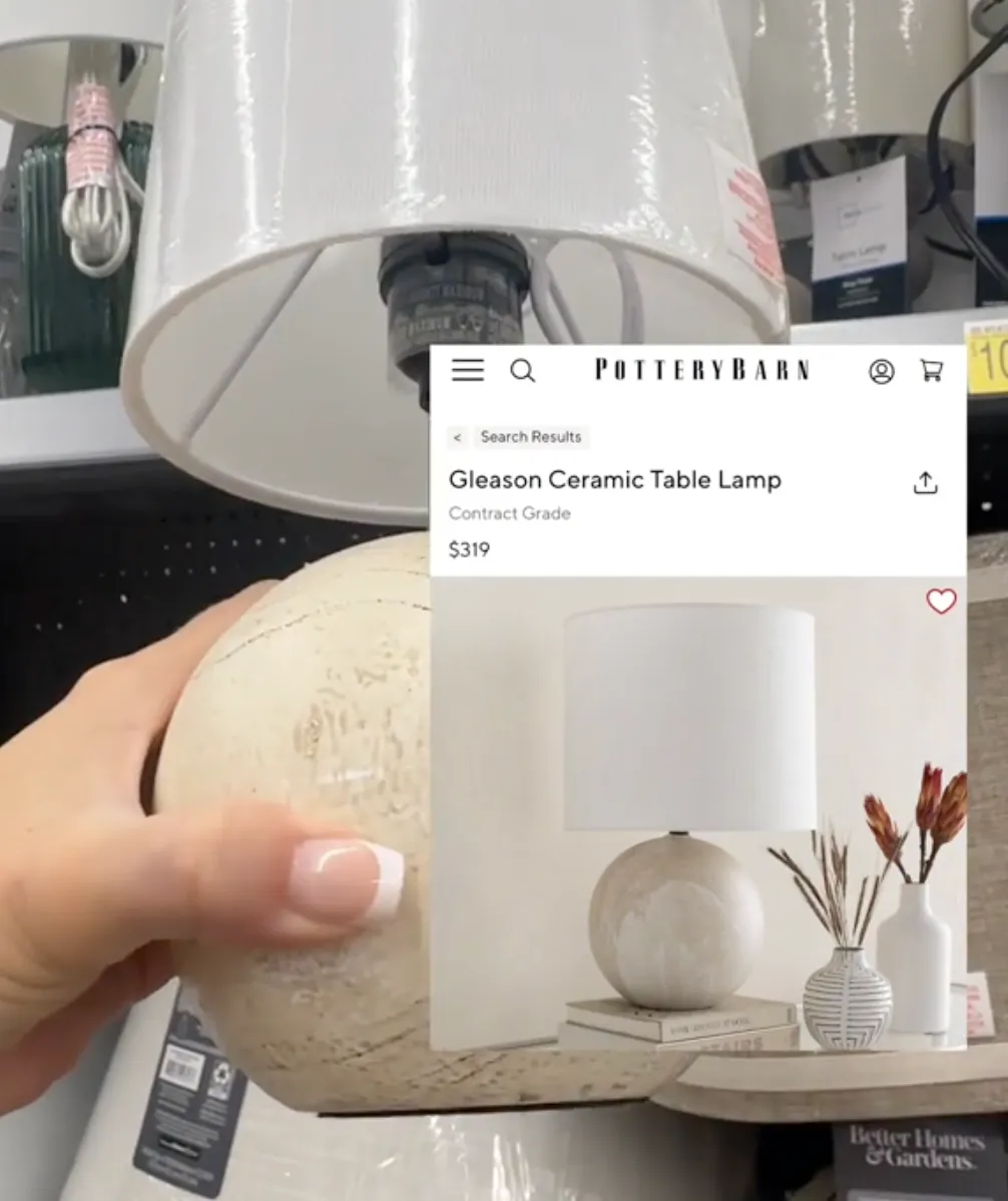 person holding up table lamp at Walmart