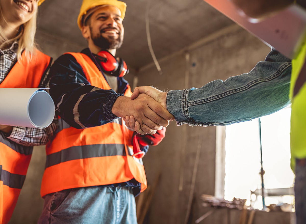 Contractors shaking hands with a client