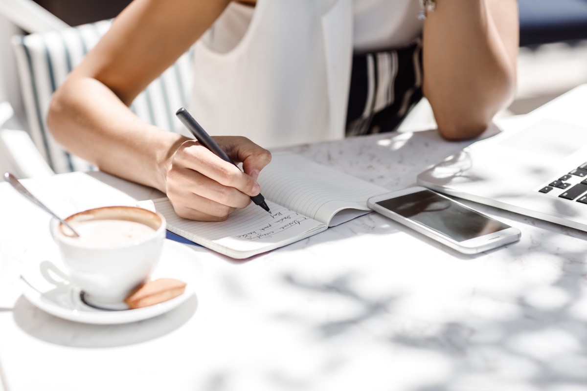 Woman a list in a notebook