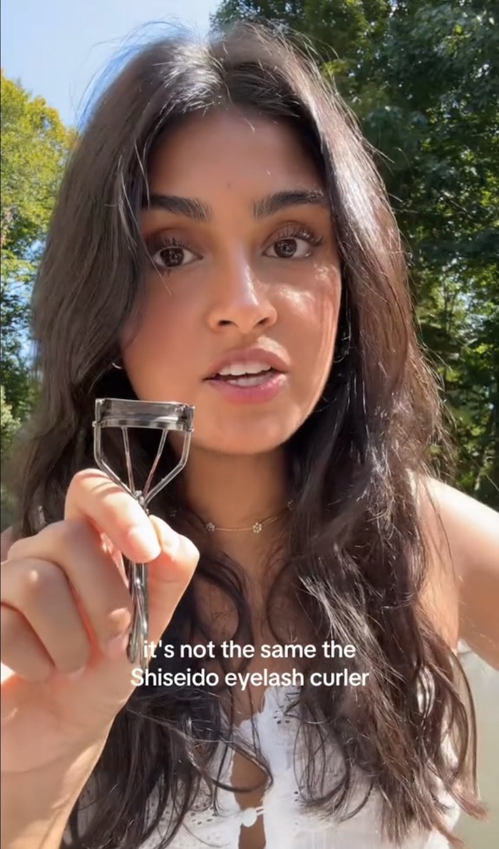 A TikToker holding up a Shiseido Eyelash Curler