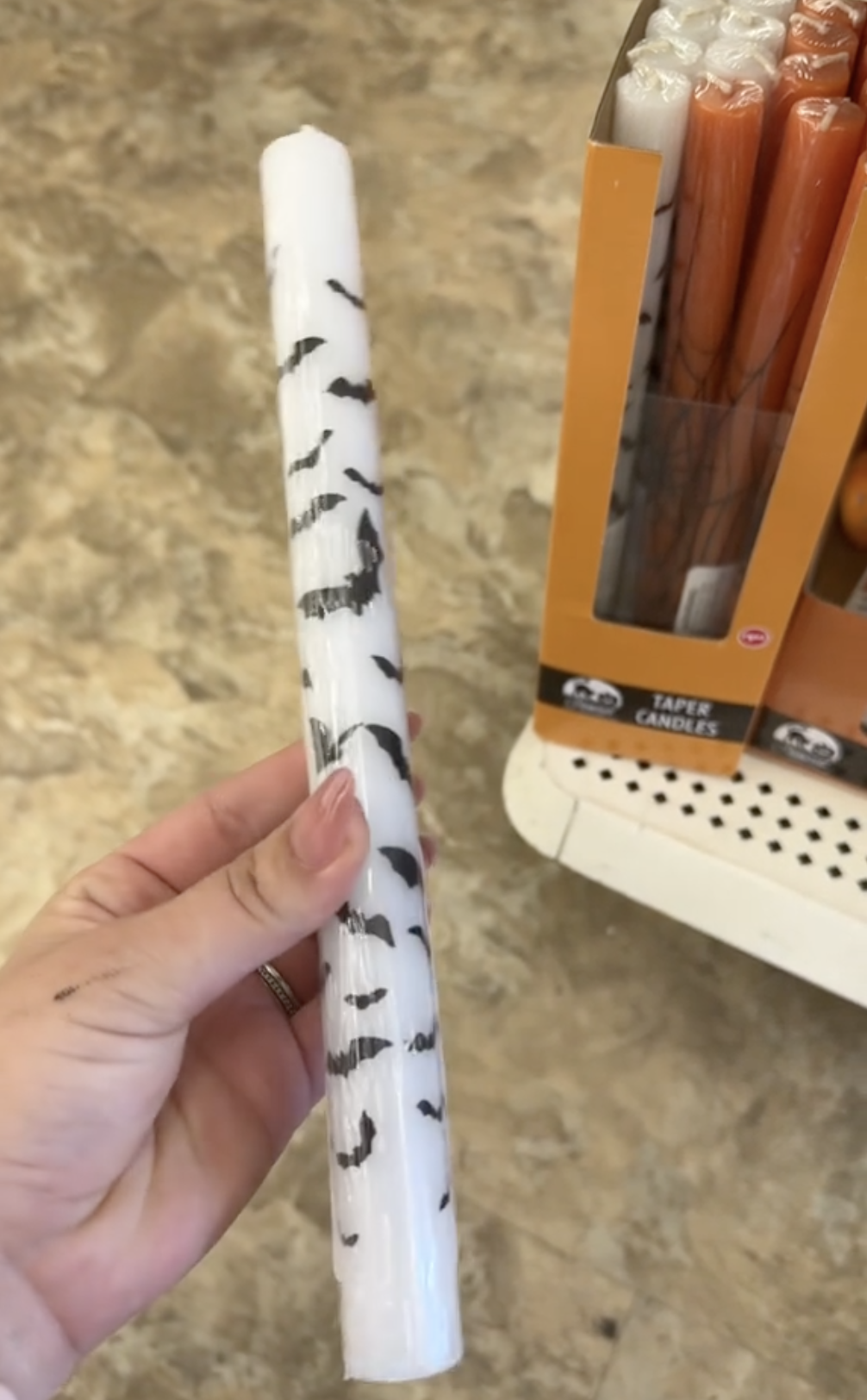 white taper candle with black bat design