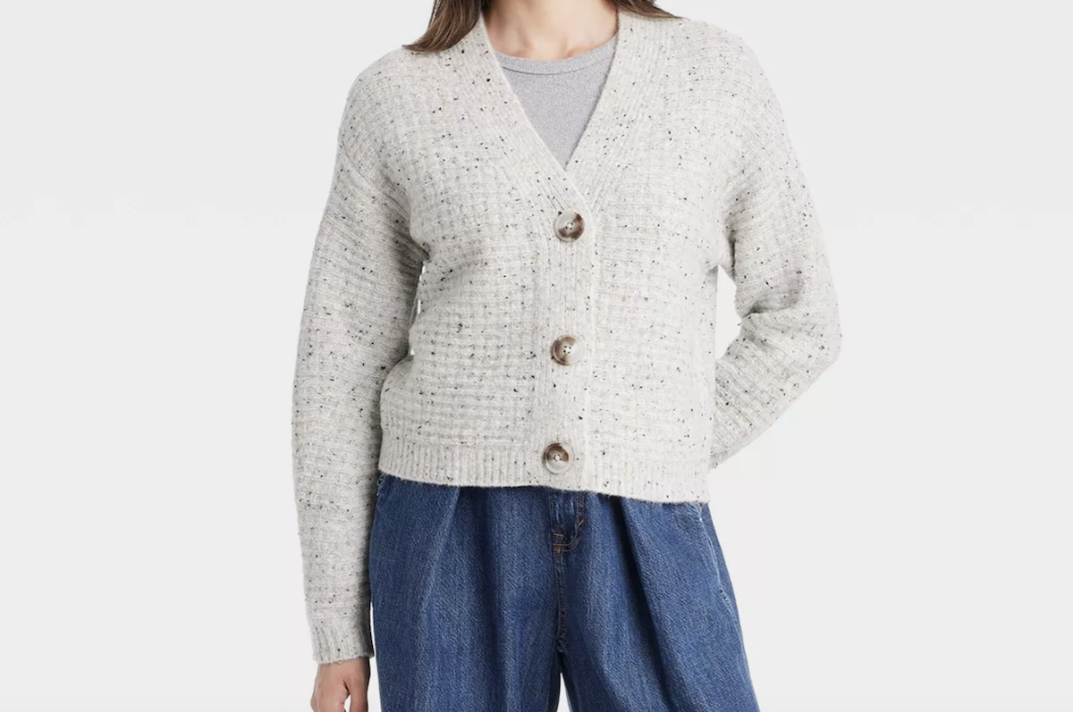 cropped image of a woman wearing a gray sweater and jeans