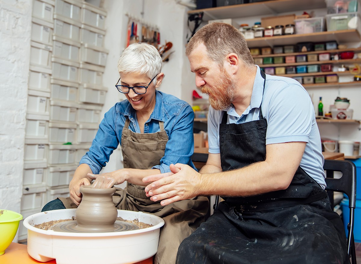 A senior woman in a pottery class