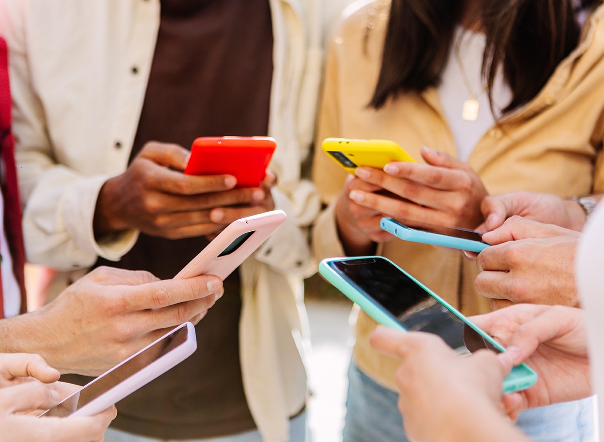 Group of teens using phones on social media