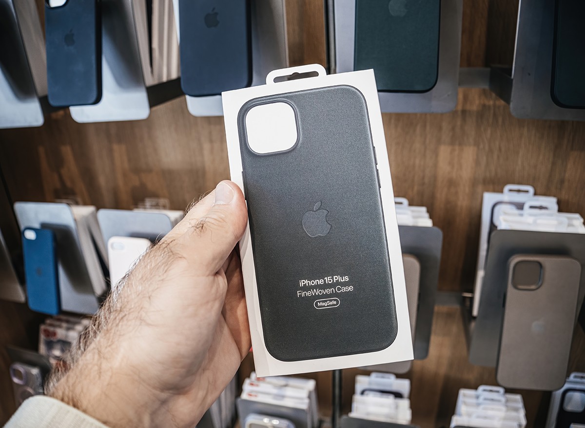 A man holding an Apple iPhone FineWoven case