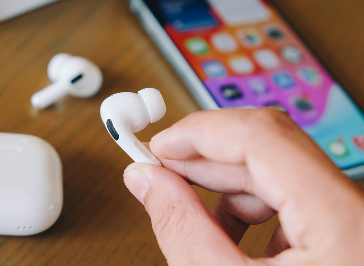 A man's hands holding Apple Airpods Pro 2