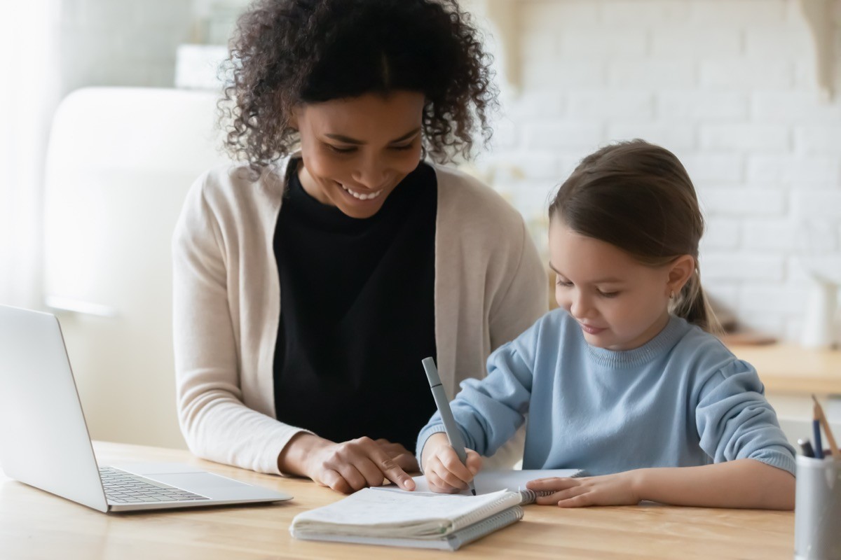 woman tutoring young girl