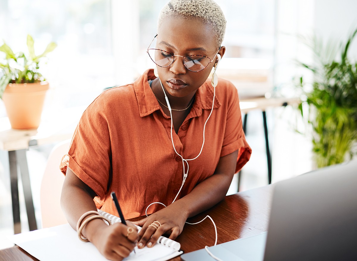 A woman sitting at a desk, transcribing audio