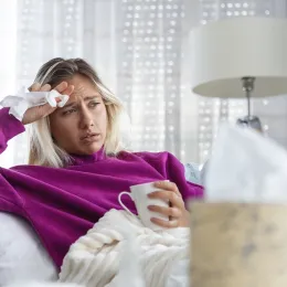 woman laying on couch sick