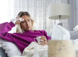 woman laying on couch sick