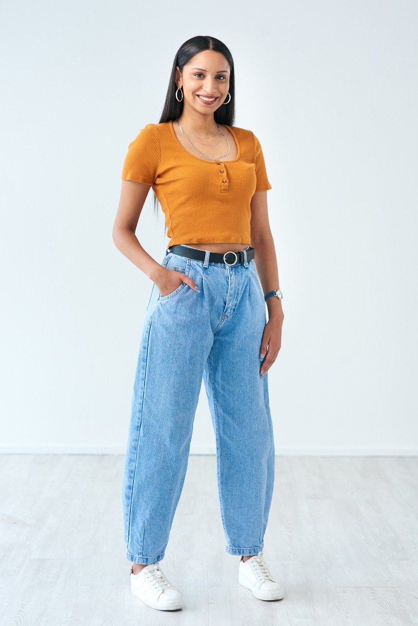 woman wearing barrel jeans and an orange t-shirt