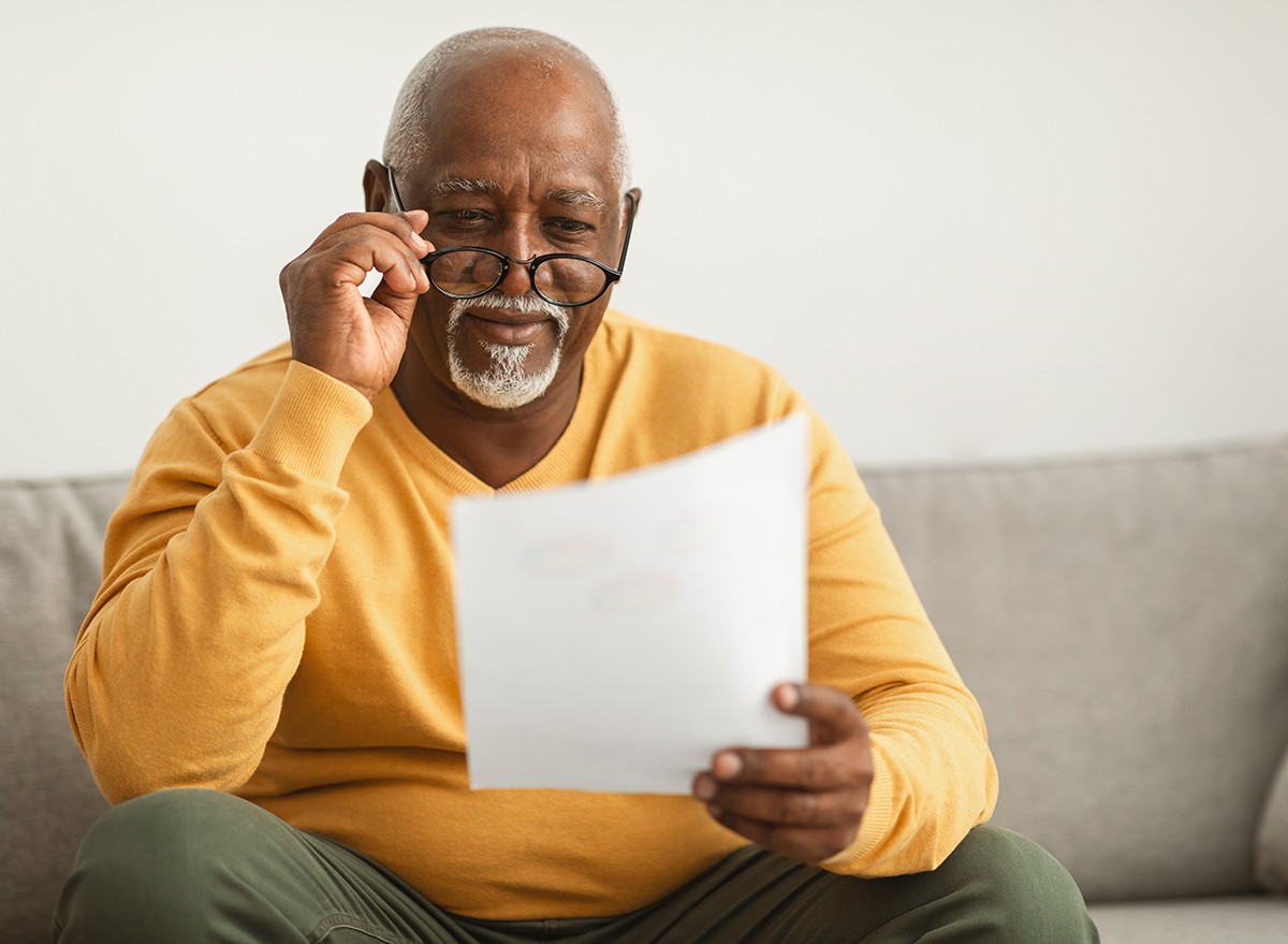 A senior man reading a letter