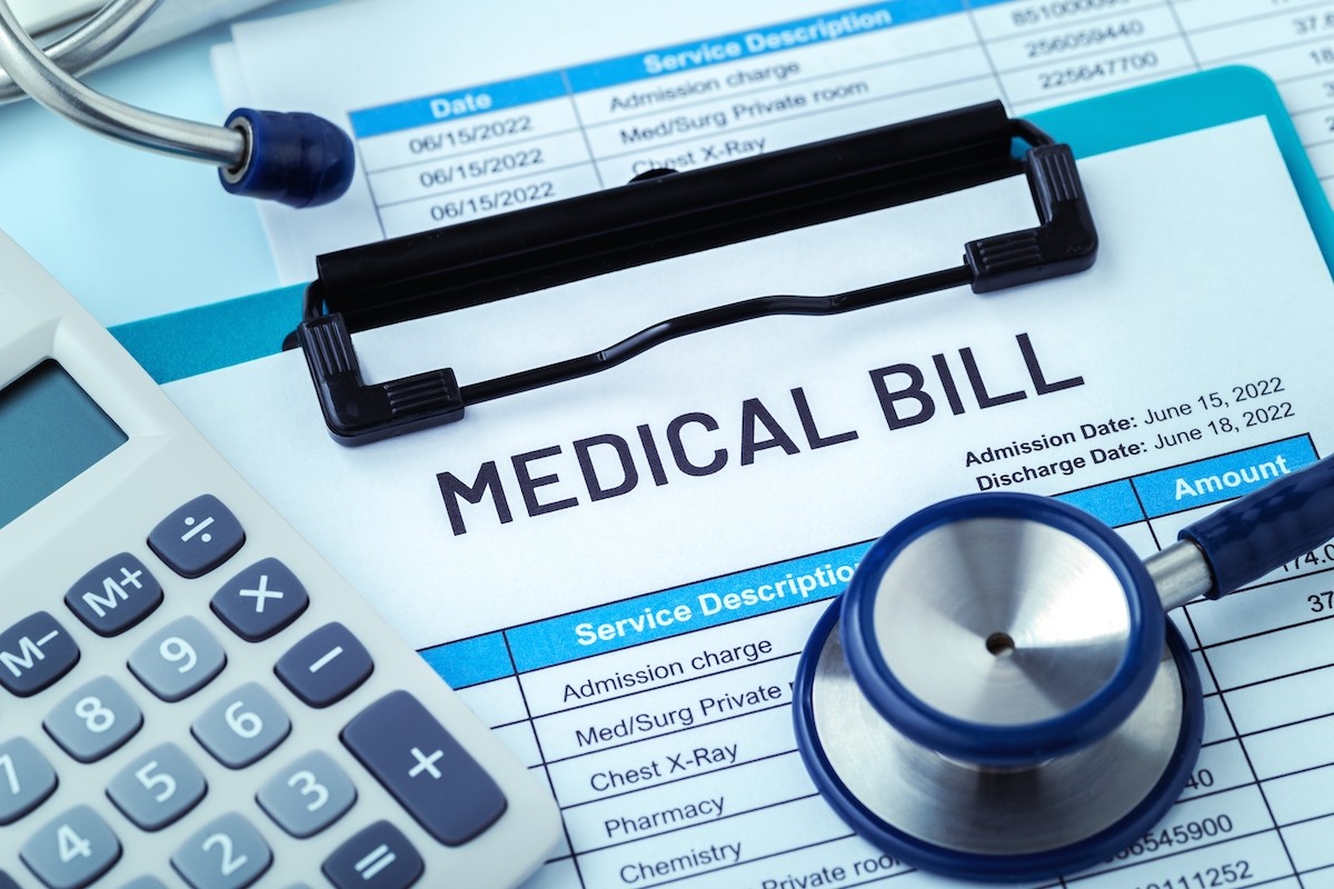 medical bill with stethoscope and calculator