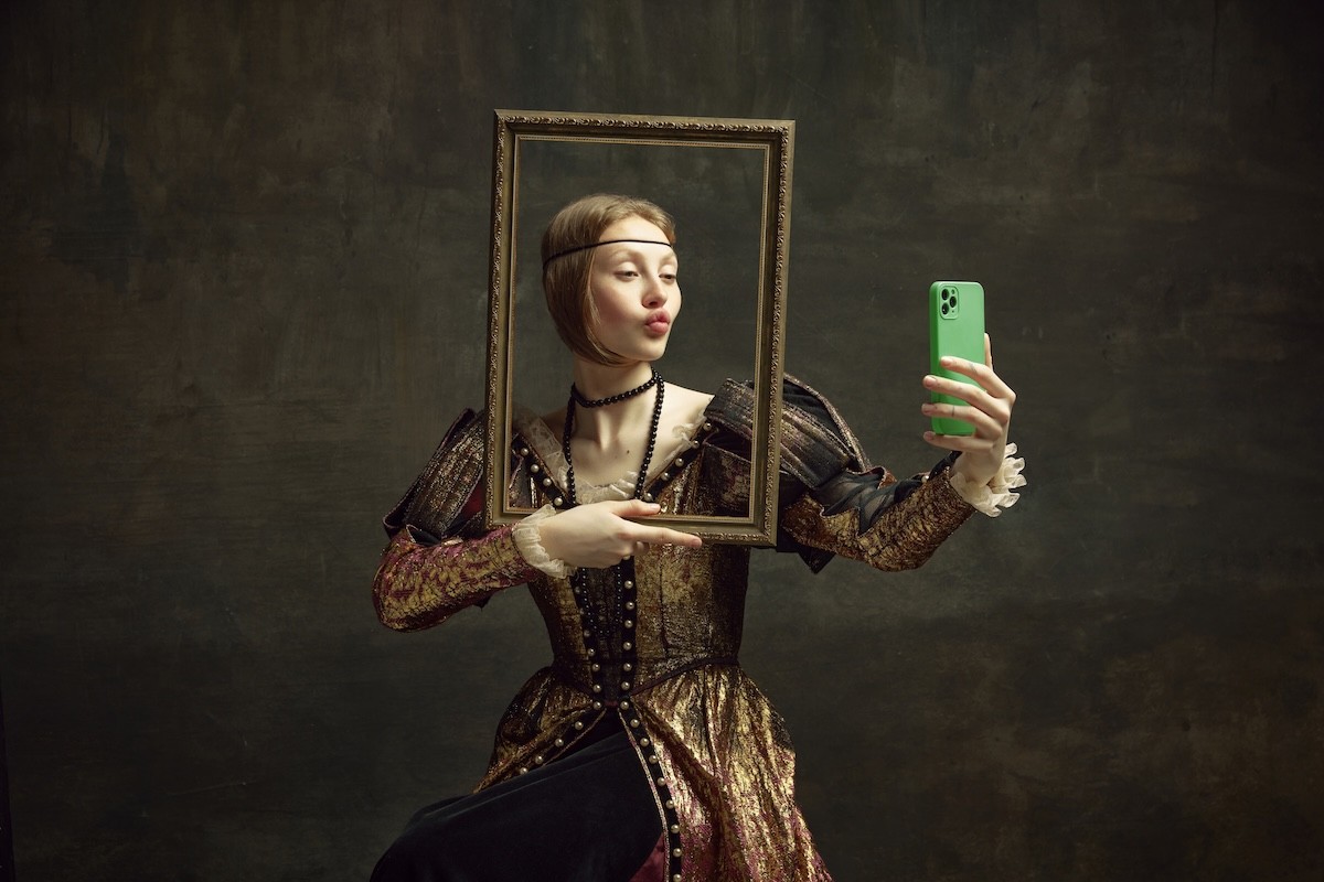 woman taking a selfie while dressed up in a Renaissance costume
