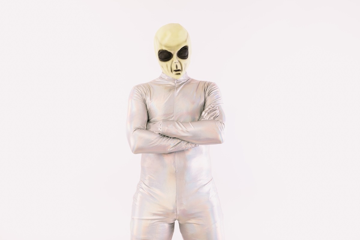 person dressed in silver alien costume