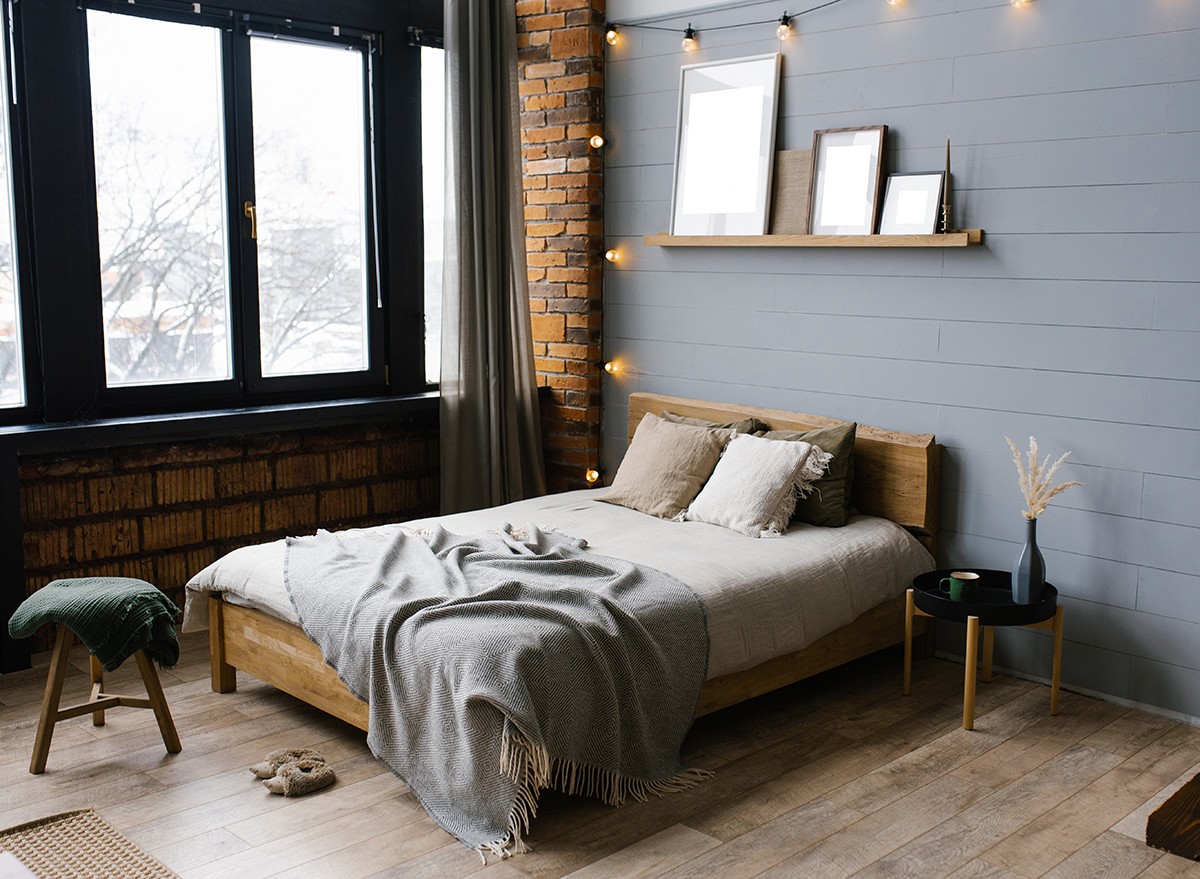 A cozy bedroom with a grey accent wall
