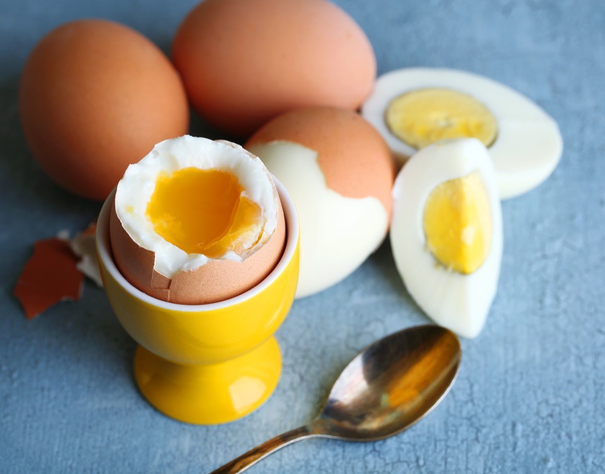 Boiled eggs on table, eggs next to spoon.