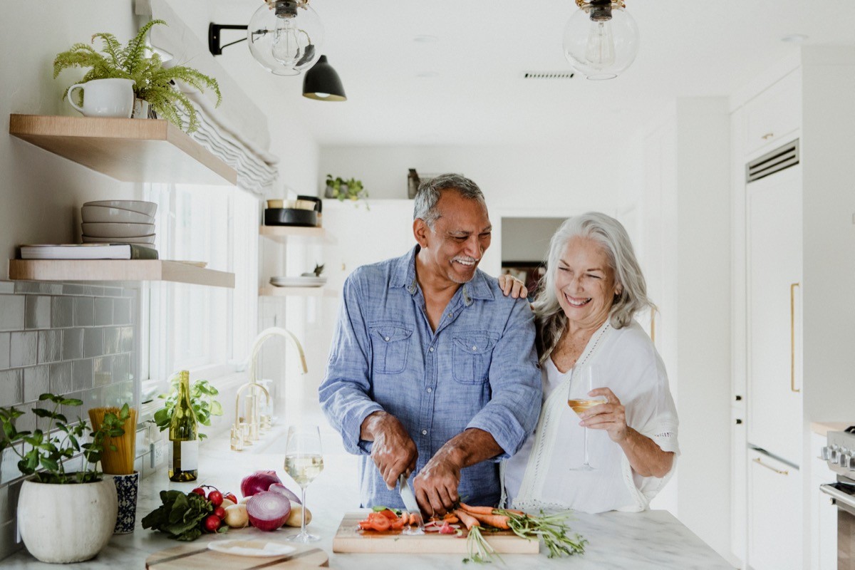 Mature couple cooking together at home