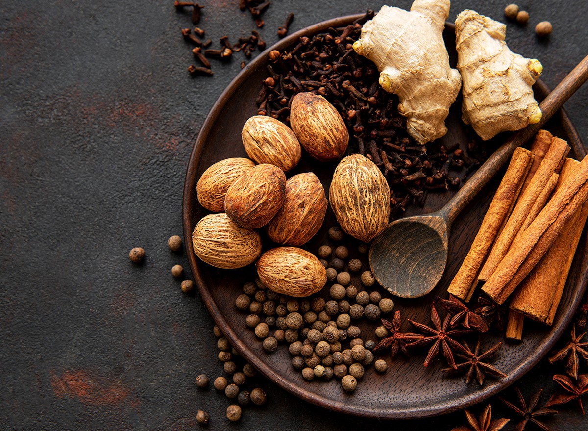 Gingerbread spices on slate - star anise, cinnamon, cloves, nutmeg, ginger, cardamom, black pepper