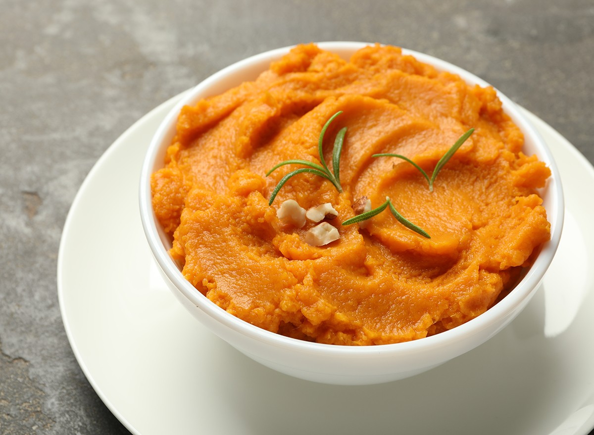 Mashed sweet potatoes in a bowl on a white plate
