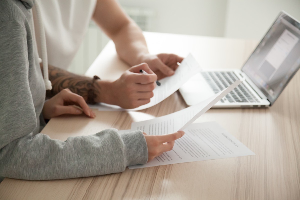 couple looking at computer and going over paperwork