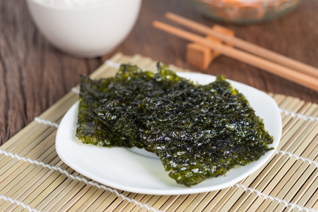 Seaweed Snacks on a white plate on a bamboo mat