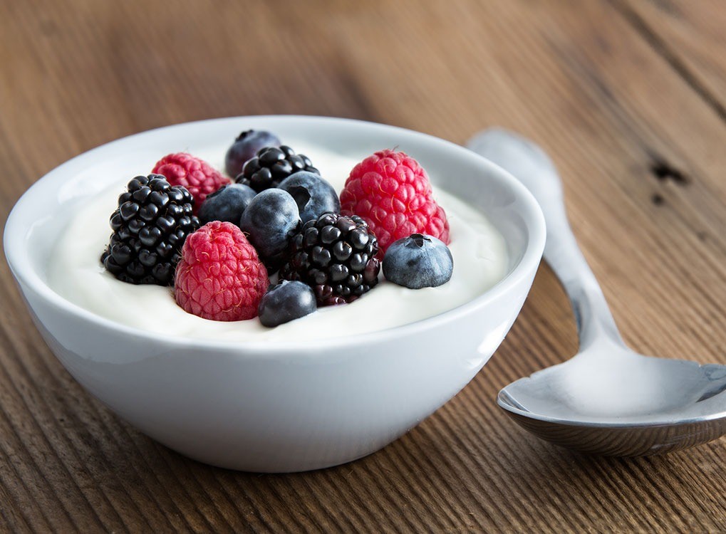 A small bowl of yogurt with berries