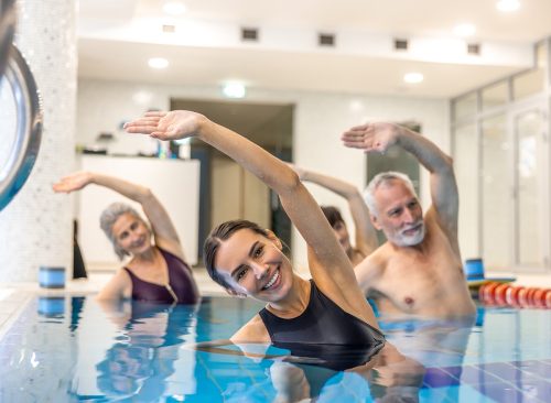 Seniors taking a low-impact water aerobics class