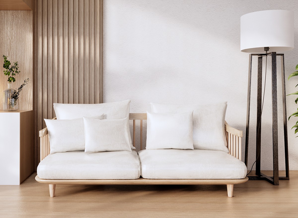 A large white couch in a small minimalist room