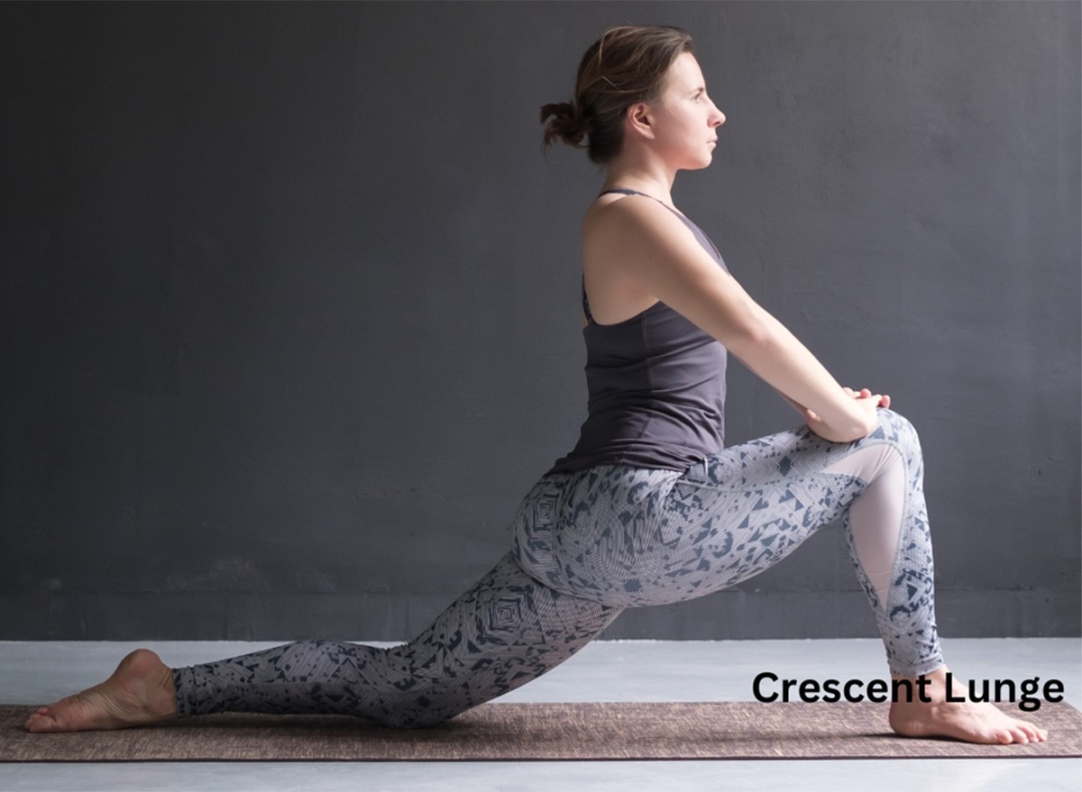 A woman does a crescent lunge stretch