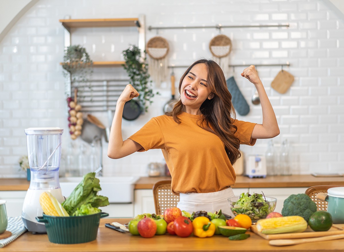 Woman in the kitchen looking happy about cooking