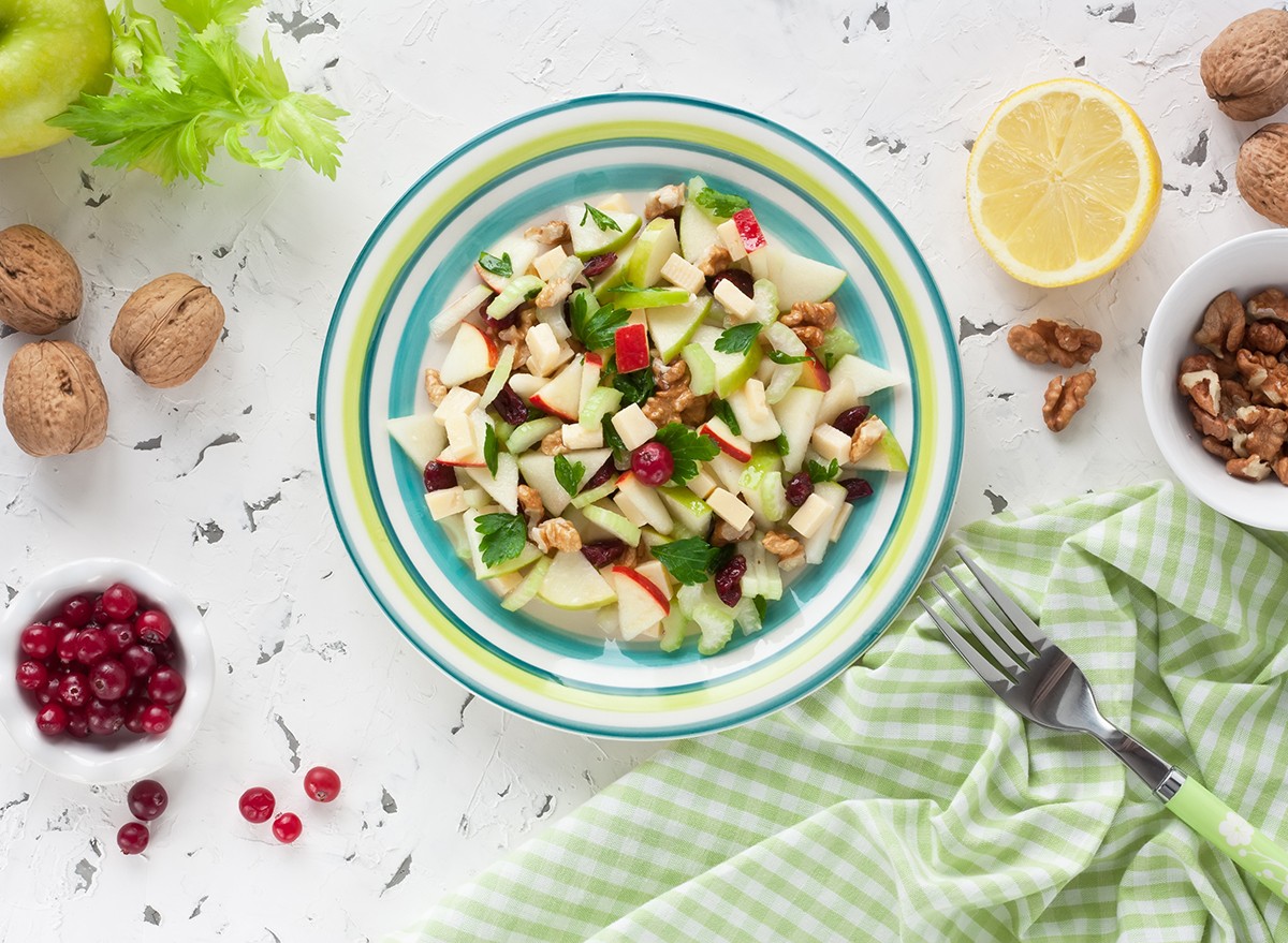 Waldorf salad with chopped apples in a bowl on a kitchen table