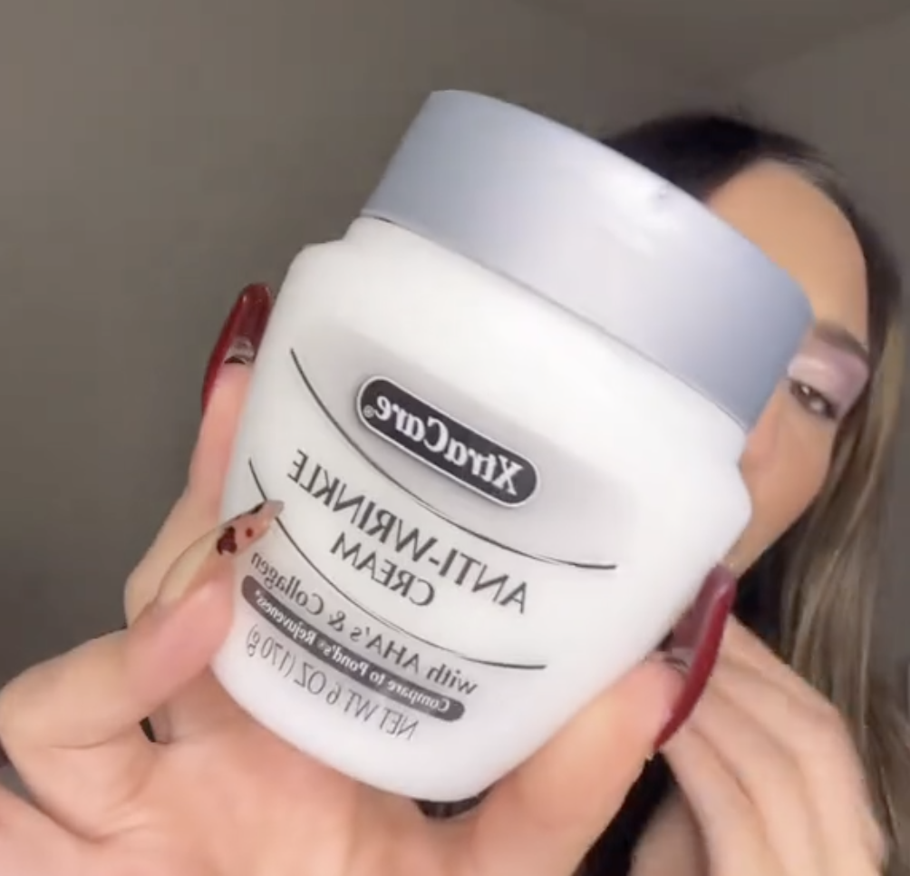 woman holding up anti-wrinkle cream from Dollar Tree