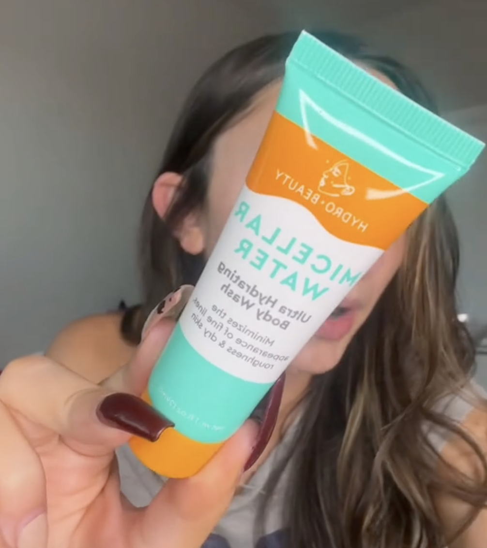 woman holding up mini micellar water from Dollar Tree