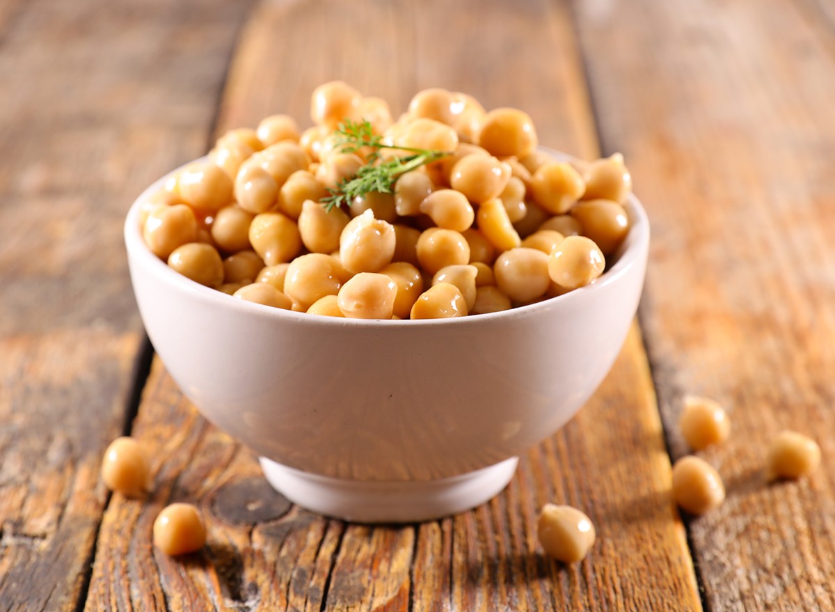 A small bowl of chickpeas on a wooden table