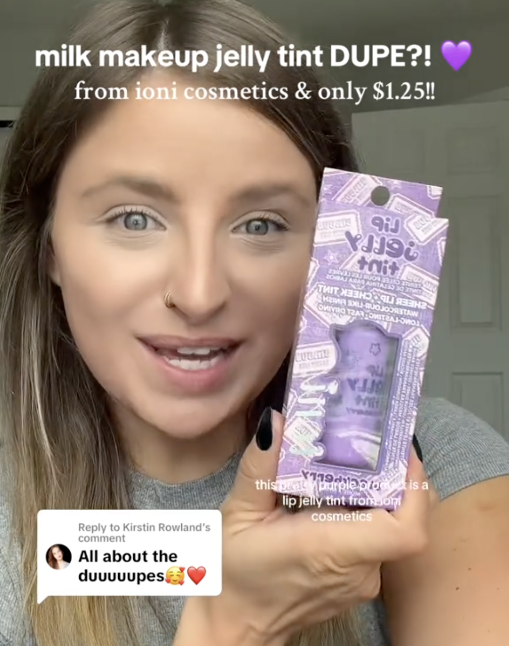 young woman holding up a lip gloss from Dollar Tree