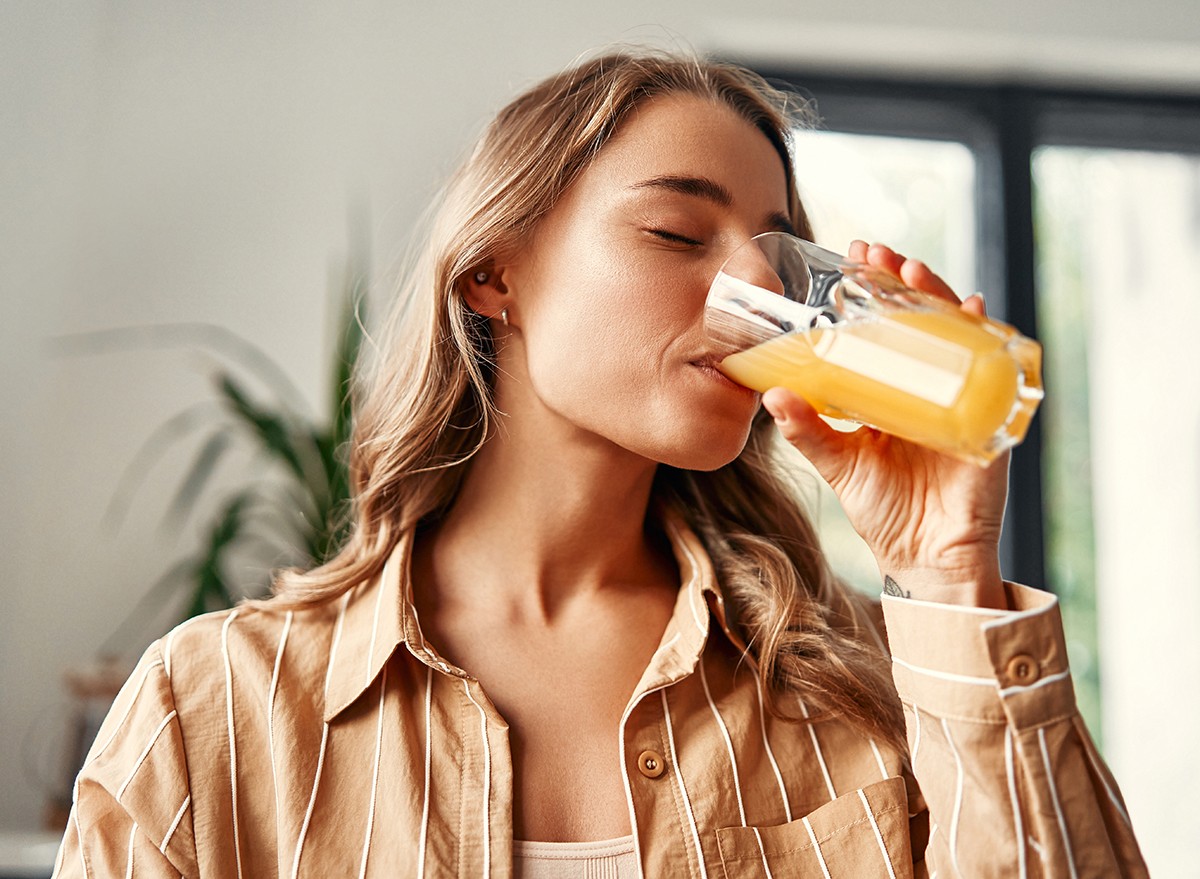 Woman drinking orange juice from a glass